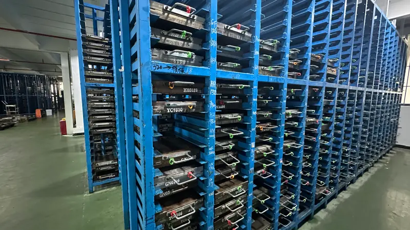 Blue storage racks holding rows of company-owned production molds